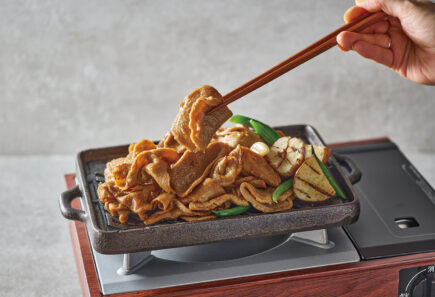 Plant-based meat being lifted with chopsticks
